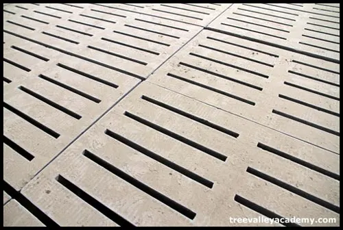 Floors with slits for cow manure to fall through.