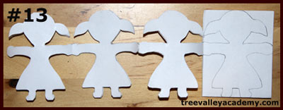 Cutting out one layer at a time of a 4 row 4 column paper doll chain. A fun art project to do with kids.