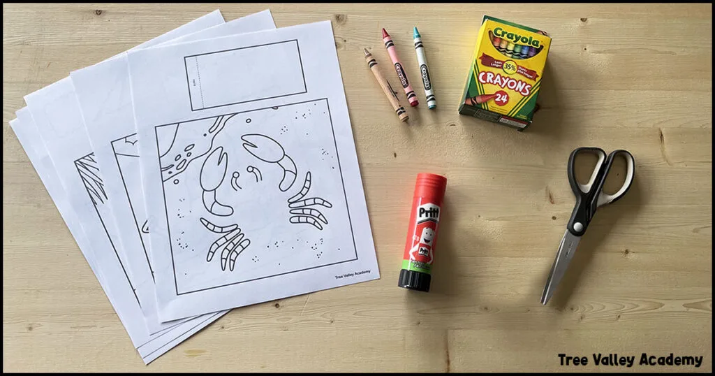 The supplies for 3D summer coloring pages for kids: the printout of the coloring pages, crayons, a glue stick, and scissors.