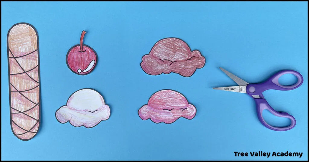 Cut-out pieces for lowercase letter i ice cream craft with scissors