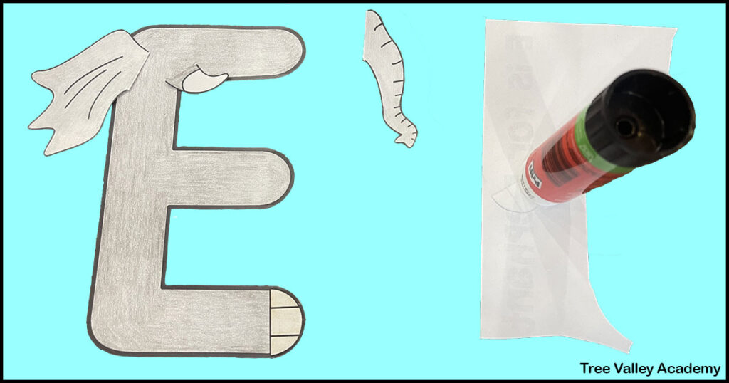 using a gluestick to glue the toenails on the letter E elephant craft