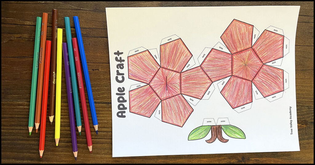 Coloring the free printable 3D apple craft template with colored pencils